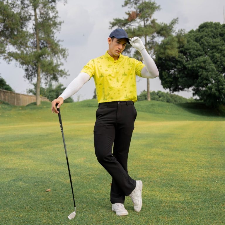 A stylish golfer showcasing the latest trends in golf fashion